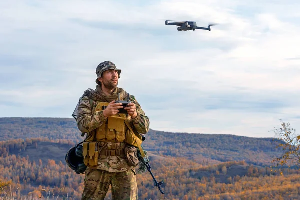 Photo of an artillery spotter or military observer launches a drone into the sky for reconnaissance in enemy territory. Modern technological methods of reconnaissance and warfare.