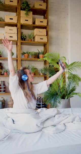 Thirty Five Year Old Woman Sits Bed Headphones Listens Music — Stock Video