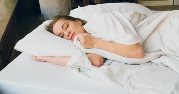 Footage Woman Sleeping She Straightens Blanket Smiles Her Sleep Lies — Wideo stockowe