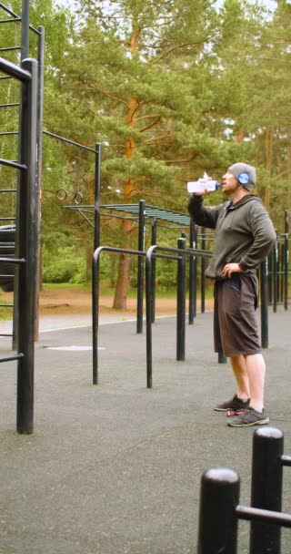 Year Old Man Drinking Water Hard Outdoor Workout Vertical Footage — Stockvideo