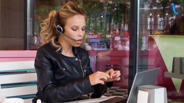 オンラインビデオ通話中の若い女性のFhd映像 彼女はノートパソコンのモニターの前のオンラインビデオ通話中に歩道カフェに座っています — ストック動画