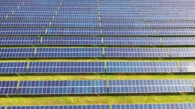 Footage of a solar panels stand in a row in the fields green energy - electrical power ecology innovation nature environment. Slow motion. 4k footage.