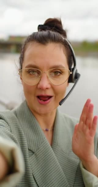 Blogger Woman Eyeglasses Headset Online Streaming She Holds Camera Arms — Vídeos de Stock