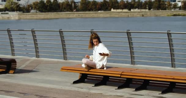 Zoom Young Woman Puts Her Smartphone Start Meditating She Listening — Vídeo de Stock