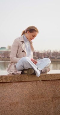 30 year old blonde chats online with her boyfriend. She is happy. She is in love. Vertical 4k footage.