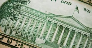 The camera moving along the back of a ten dollar bill - the US Treasury building on the back of a ten dollar bill. 4k footage. Macro.