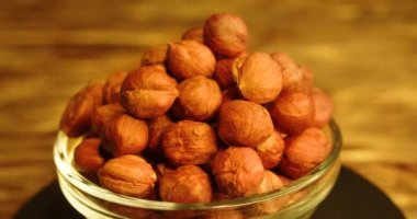 Smooth rotation of hazelnuts. Close-up slow motion 4k footage.