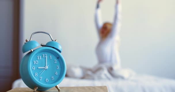 Footage Alarm Clock Foreground Blurred Young Blonde Woman Woke Stretching — Vídeo de Stock