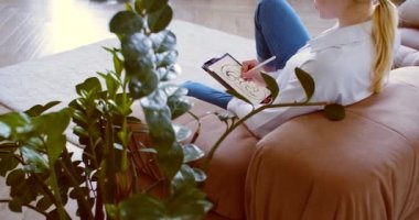Cropped video of a young woman draws a beautiful image on the digital pad screen. Graphic designer working at home. 60 fps 4k footage.