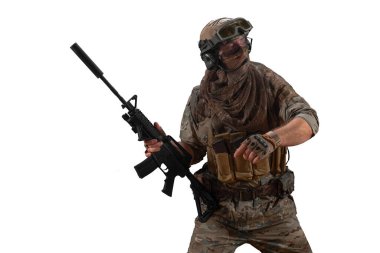 Cropped photo mercenary soldier walks with an automatic rifle in his hand and looking by side. Professional special forces soldier during a special operation behind the enemy line. Photo isolated on