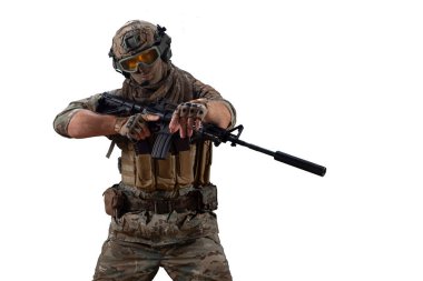 Cropped photo mercenary soldier walks with an automatic rifle in his hand and looking at camera. Professional special forces soldier during a special operation behind the enemy line. Photo isolated on
