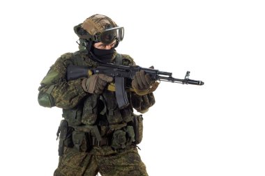 Cropped photo of a russian mercenary soldier with AK-74 in his hand and aiming in enemy. Professional special forces soldier during a special operation. Photo isolated on white.
