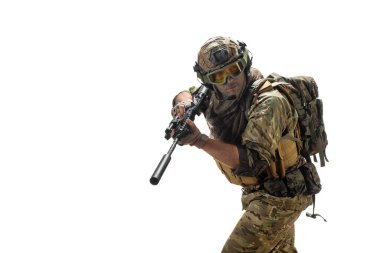 A mercenary soldier with AK-74 in his hand and aiming in enemy. Professional special forces soldier during a special operation. Photo isolated on white.