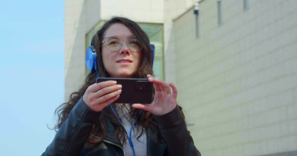 年轻的嬉皮士女人在市中心散步的时候用她的智能手机拍照 慢动作4K视频 — 图库视频影像