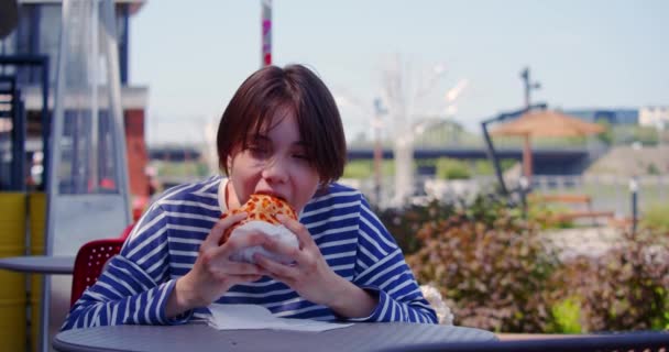 少女在人行道咖啡店吃汉堡包 慢动作4K镜头 — 图库视频影像