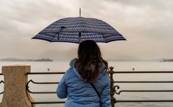 Attractive Middle Aged Woman Sitting Rain Umbrella Front Lake Maggiore — Stock Photo, Image
