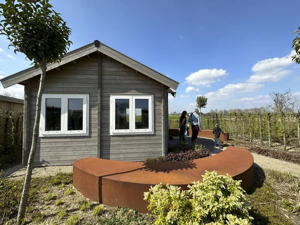 Tiny house garden. Family in the garden. Corten steel platforms. Appeltern, Netherlands, April 09, 2023: The garden inspiration park for the whole family