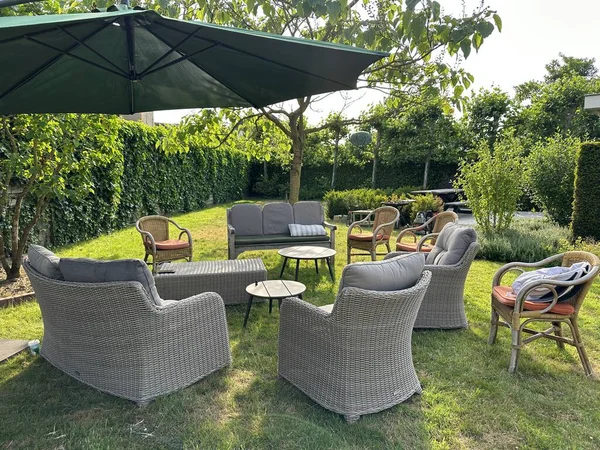 Bahçedeki Rattan mobilyası ve şemsiyesi