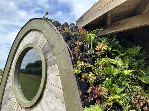 Green living roof with plants. Green roof covered with specially black planters with felt pockets for plants close-up