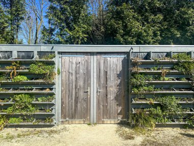 Geri dönüşümlü plastik atıktan yapılmış yeşil duvarları olan çevre dostu bir depo. Silvolde, Hollanda 'da modern yerleşim alanı