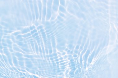 Defocus blurred transparent blue colored clear calm water surface texture with splashes and bubbles. Trendy abstract nature background. Water waves in sunlight with copy space. Blue water shine