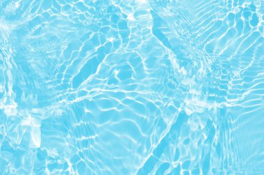 Defocus blurred transparent blue colored clear calm water surface texture with splashes and bubbles. Trendy abstract nature background. Water waves in sunlight with copy space. Blue water shine
