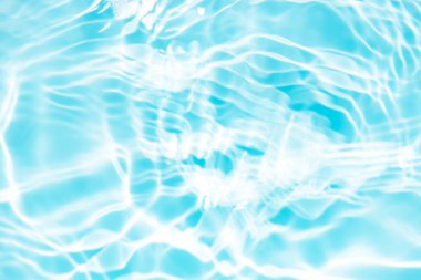 Defocus bulanık mavi şeffaf, berrak, durgun su yüzeyi dokusu sıçrama ve kabarcıklarla bulanıklaştırılmış. Moda soyut doğa geçmişi. Güneş ışığında fotokopi uzayıyla birlikte su dalgaları. Mavi suluboya parlıyor.