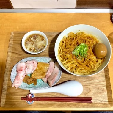Close up ramen noodles with egg are provided in white bowls. Delicious food concept. Top view.
