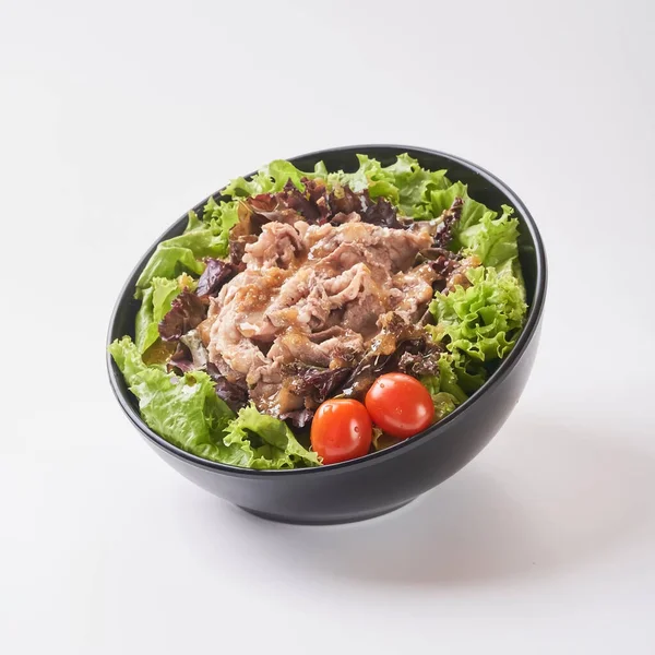 Close up healthy vegetables in black bowl isolated on white background. Healthy food concept