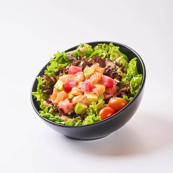 Close up healthy vegetables in black bowl isolated on white background. Healthy food concept