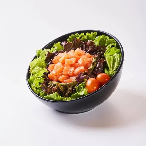 Close up healthy vegetables in black bowl isolated on white background. Healthy food concept