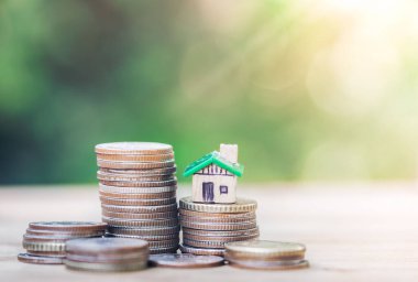 House placed on coins. planning savings money of coins to buy a home concept, concept for property ladder, mortgage and real estate investment. for saving or investment for a house.