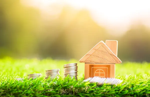 House and coins placed on grass. concept of real estate investment. planning savings money of coins to buy a home concept. concept for property ladder, mortgage and real estate investment.