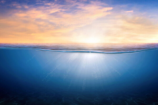 BLUE UNDER WATER waves and bubbles. Orange and golden sunset sky over calm sea with sunlight reflection, Tranquil sea harmony of calm water surface. sunset sky and calm blue ocean.