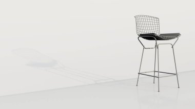 Siyah minderli beyaz bir sandalye beyaz bir duvarda oturuyor. Sandalye metalden yapılmıştır ve bir ağ tasarımına sahiptir. Sandalye modern ve şık, minimalist bir tasarımı var.