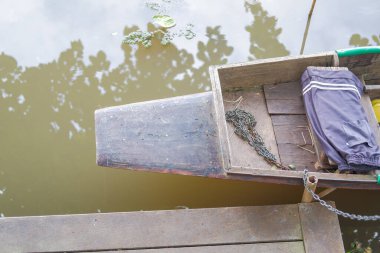 Köylülerin ahşap tekneleri direğe bağlı zincirlerle kenetlendi. yokluğunda.