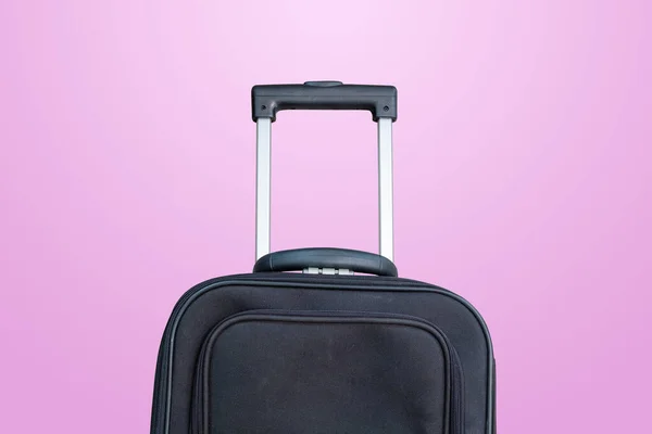 black travel bag on a pink background