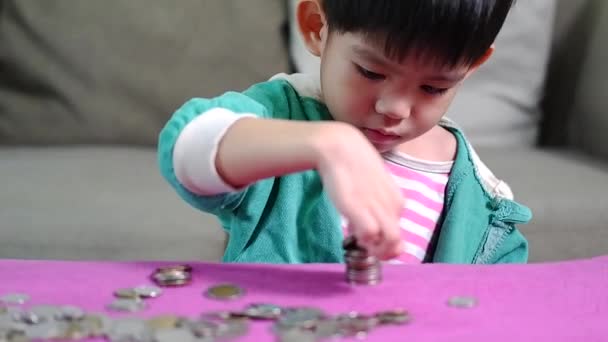 Asian Boy Arranging Coins Row Practice Saving Money — Stock Video