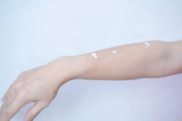 Woman\'s arm with skin cream waiting for skin care rub