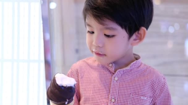 Little Asian Boy Eating Delicious Chocolate Ice Cream — Stock Video