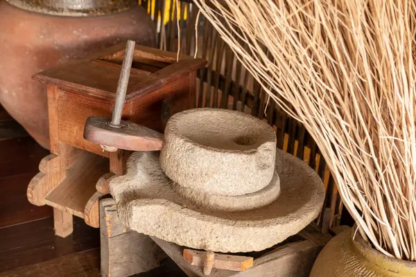 An old manual stone flour mill used in traditional Asian kitchens.
