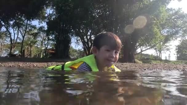 Little Asian Boy Wearing Life Jacket Plays Stream Recorded Water — Stock Video