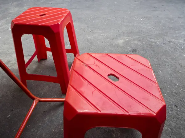 stock image The red plastic stool of a roadside street food restaurant