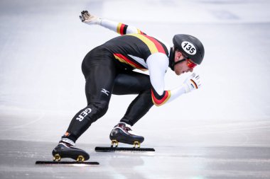 Dresden, Germany, February 01, 2019: German speed skater competes during the ISU Short Track Speed Skating World Championship in Dresden, Germany. clipart