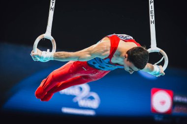 Szczecin, Poland, April 10, 2019:Tovmasyan Artur of Armenia competes on the rings during the European artistic gymnastics championships clipart