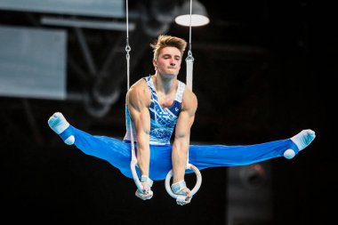 Szczecin, Poland, April 10, 2019:olympic athlete Mikkola Eeli competes on the rings during the European gymnastics championships clipart