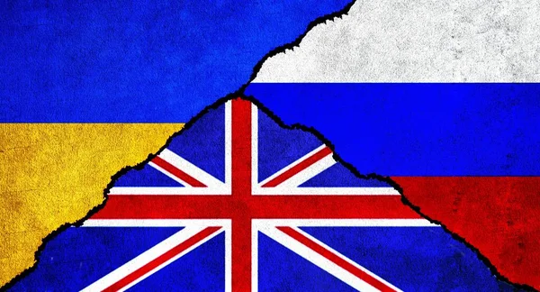 Russia, Ukraine and United Kingdom (UK) flag together on wall. Diplomatic relations between Russia, Britain and Ukraine