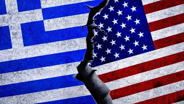 USA and Greece painted flags on a wall with a crack. United States of America and Greece relations