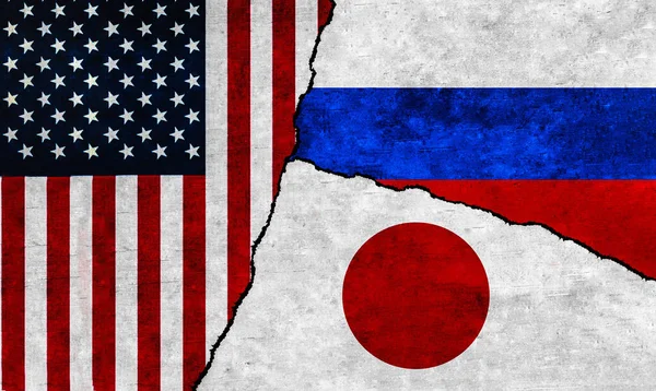 USA, Russia and Japan flags on wall with crack. United States of America, Japan and Russia relations