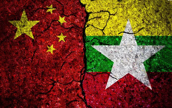 China and Myanmar painted flags on wall with grunge texture. China and Myanmar conflict. China vs Myanmar